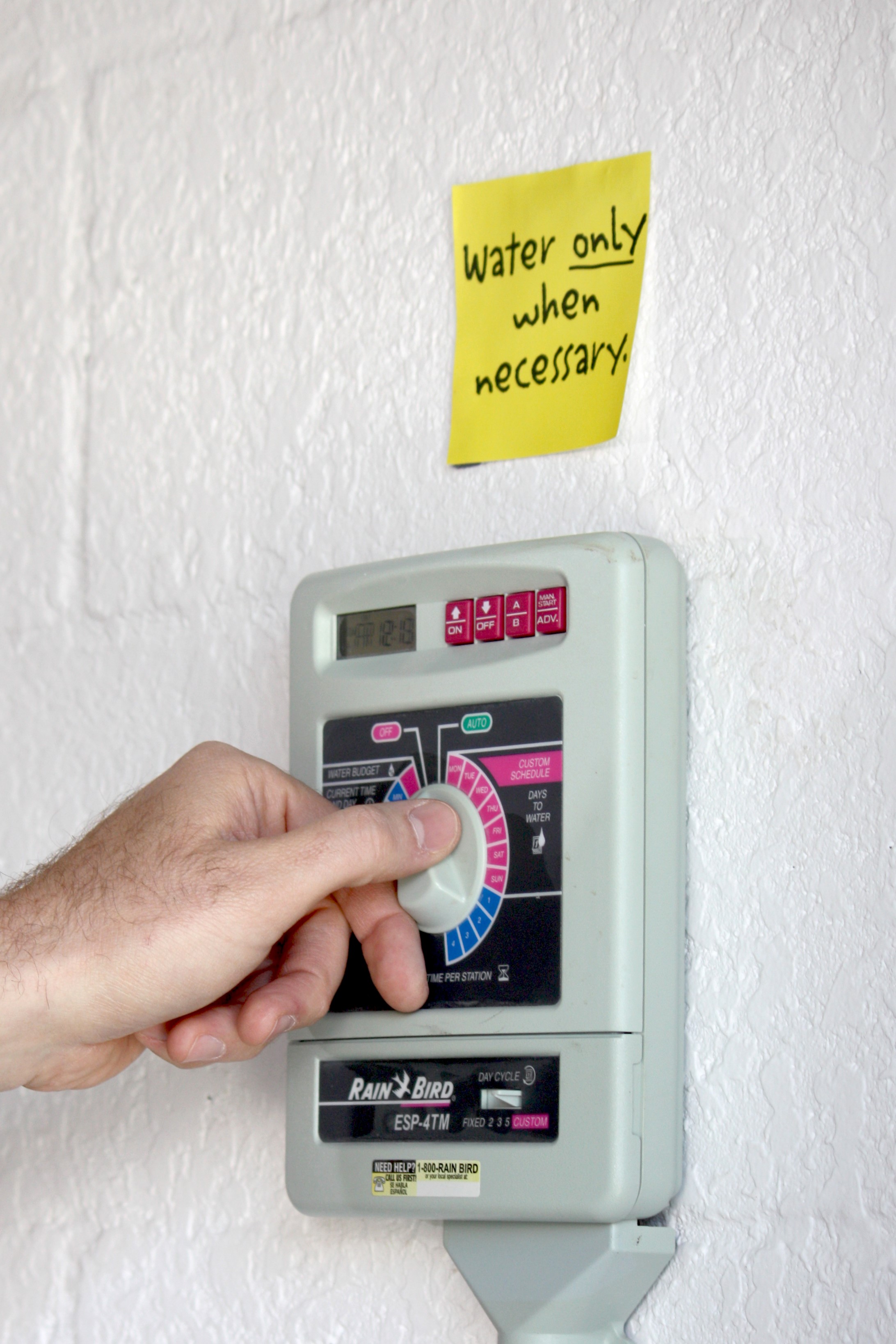 Image of irrigation timer, with reminder to water only when necessary